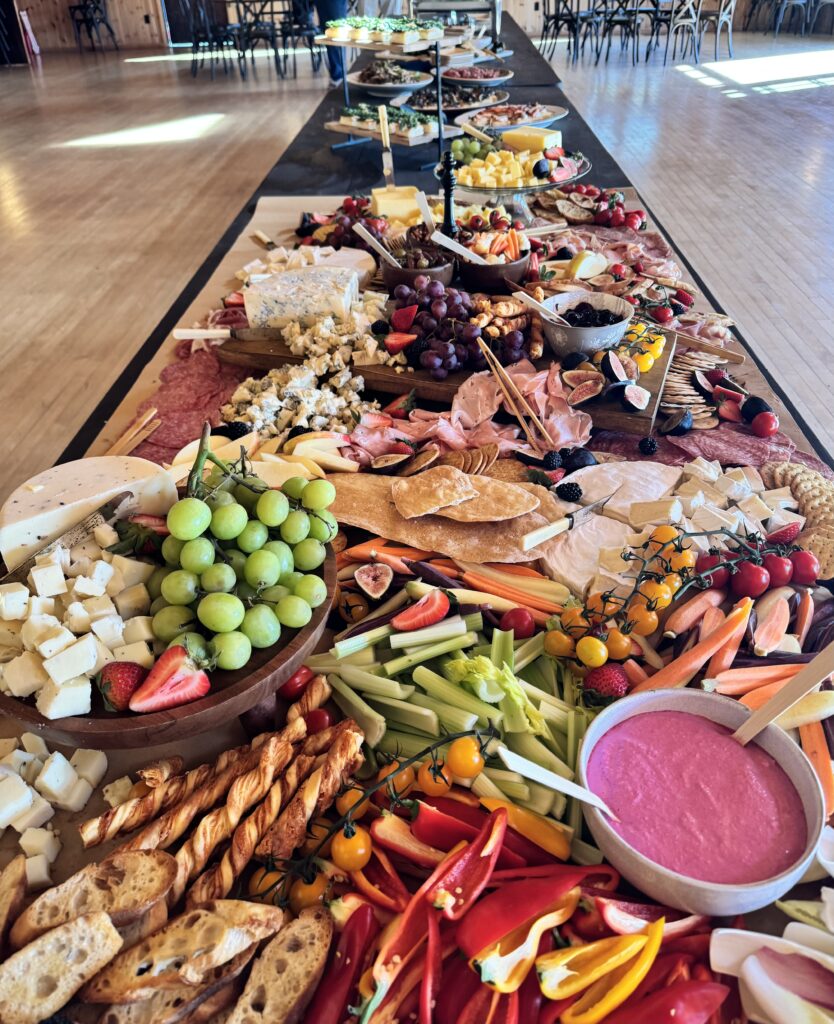 catering image of a grazing board of charcuterie, cheese, veggies, fruit, crackers